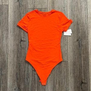 Neon orange body suit